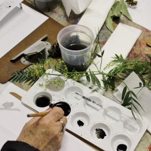 A hand painting and doing craft on a table