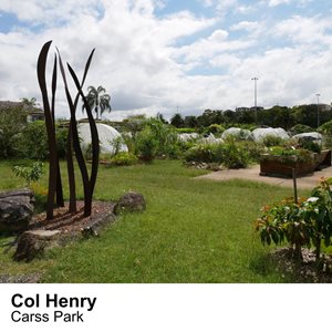 A metal sculpture next a community garden