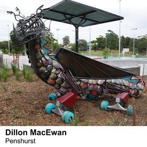 A dragon sculpture made of skateboards and bicycle parts.