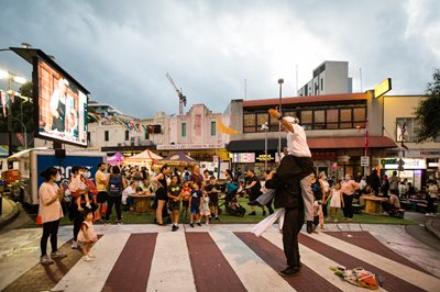 Image of performers and crowds on the street