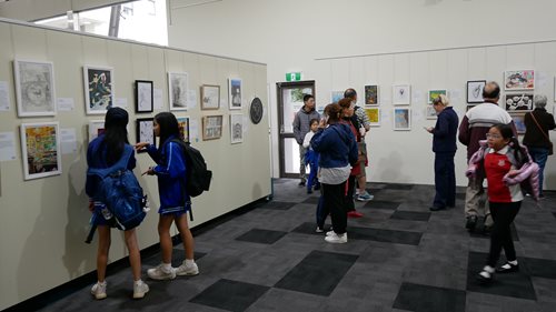 People viewing Georges River Art Prize Youth & Little Artist categories at the Clive James Library and Service Centre, Kogarah