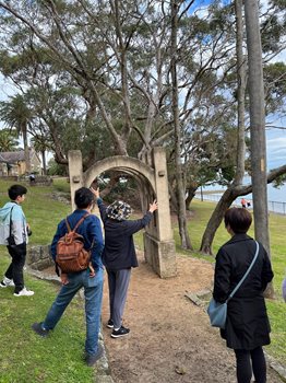 A group of people looking at a sculpture in a park