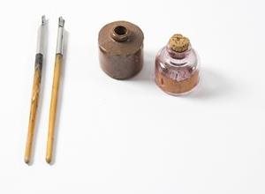 Letter writing tools showing ink, brushes and other tools