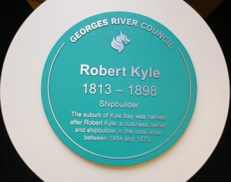 Historical Marker - Robert Kyle 1813-1898. Reads: Shipbuilder. The suburb of Kyle Bay was named after Robert Kyle, a business owner and shipbuilder in the local area between 1854 and 1873.