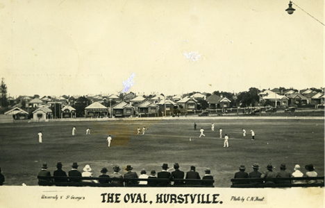 Sepia photo of cricket game between University vs St George's at Hurstville Oval. Photo caption reads The Oval, Hurstville. University v St George's Photo by CN Frost