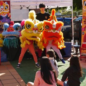 kids trying to do lunar new year dances with dragon costumes