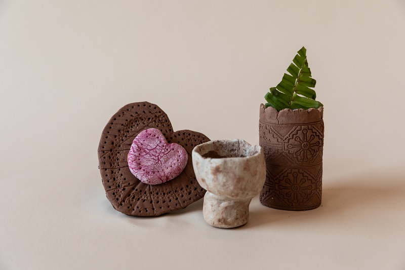 Three clay artwork pieces shaped like a heart, cup and cylinder vase..jpg