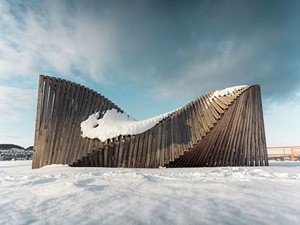 Wood sculpture on a snow landscape