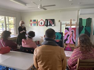 Artist giving a talk to a group of adults