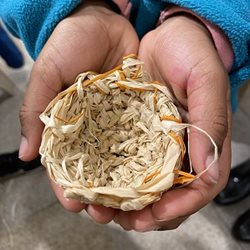 Image of weaving artwork being held by hands