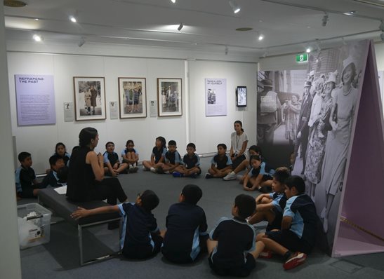 school group sitting up in the floor while doing an educator led program