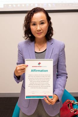 Image of Cr Nancy Liu holding up Signed Councillor Affirmation