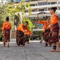 Young adults dancing wearing indonesian traditional clothes