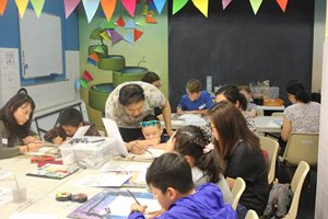 artist Dawei Xu doing an art program with kids