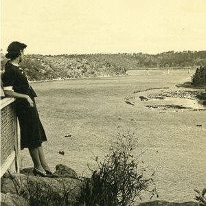 Sepia photograph of a woman standing at look out