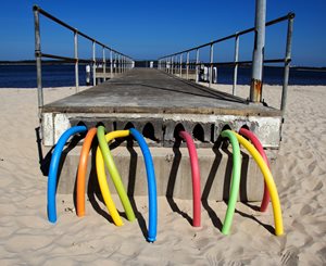 colorful foam sticks creating an sculpture by the sea